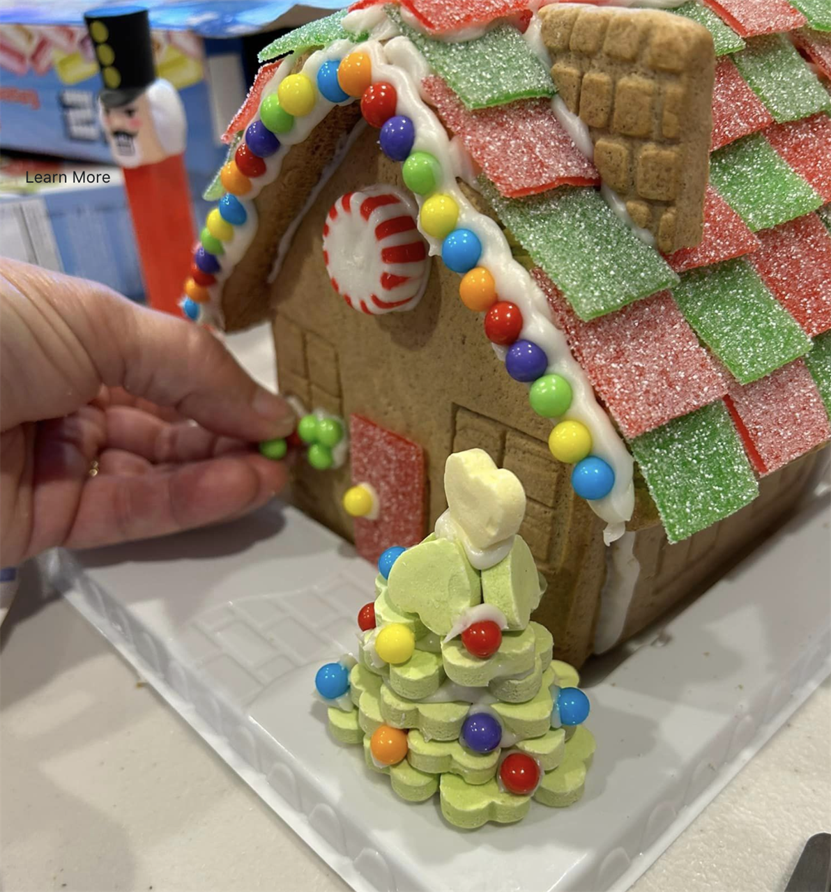 gingerbread house with hand